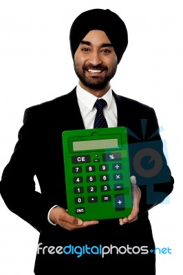 Corporate Man Showing Big Green Calculator Stock Photo