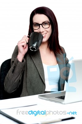 Corporate Woman Enjoying Coffee At Work Desk Stock Photo