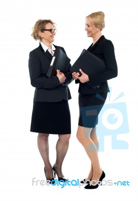 Corporate Women Interacting With Each Other Stock Photo