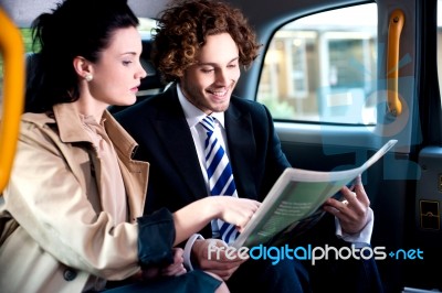 Corporates Discussing Finances Published In Newspaper Stock Photo