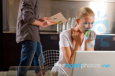 Couple At Home Using Laptop Stock Photo