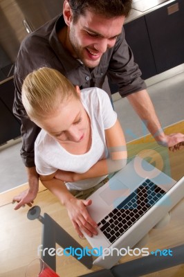 Couple At Home Using Laptop Stock Photo