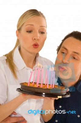Couple Celebrating Birthday With Cake Stock Photo