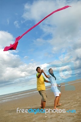 Couple Flying Kite Stock Photo
