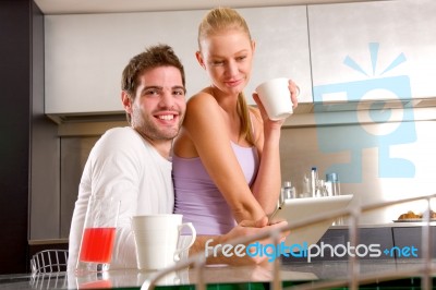Couple In Kitchen Having Breakfast Stock Photo