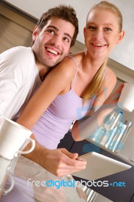 Couple In Kitchen Having Breakfast Stock Photo