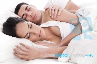 Couple Lying In Bed Sleeping Together Stock Photo
