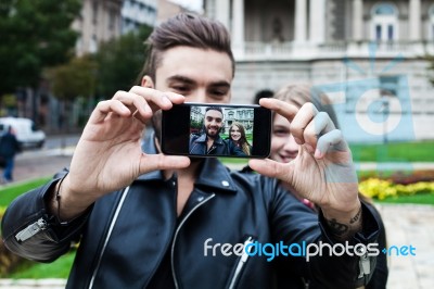 Couple Of Hipsters Having Fun With Smartphone Photography Stock Photo