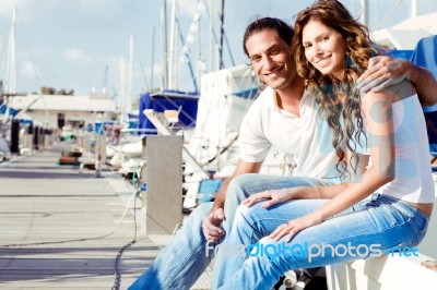 Couple Sitting On Foot Bridge Stock Photo