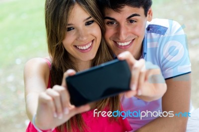 Couple Taking Photo Of Themselves With Smart Phone On Romantic P… Stock Photo