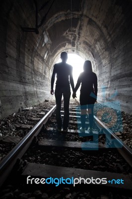 Couple Walking Together Through A Railway Tunnel Stock Photo