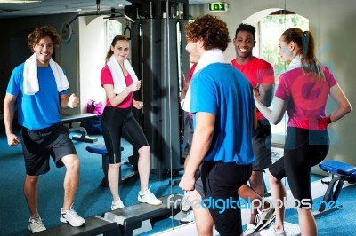 Couple With Personal Fitness Trainer In The Gym Stock Photo