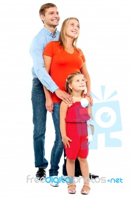 Couple With Their Girl Child Looking Upwards Stock Photo
