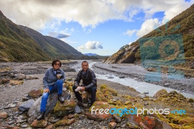 Couples Of Asian Traveler Taking A Photograph In Franz Josef Glacier Important Traveling Destination In South Island New Zealand Stock Photo