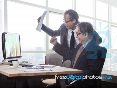 Couples Of Business Man Happiness Emotion When Looking To Business Graph Report On Computer Monitor Stock Photo