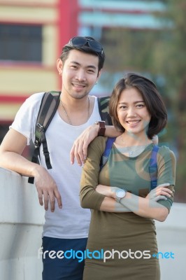 Couples Of Younger Asian Man And Woman Relaxing With Happy Face On Vacation Trip Stock Photo