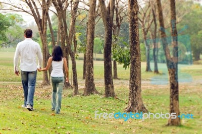 Couples Walk Hand In Hand Stock Photo