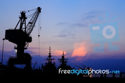 Cranes In Dockside At Sunset Stock Photo