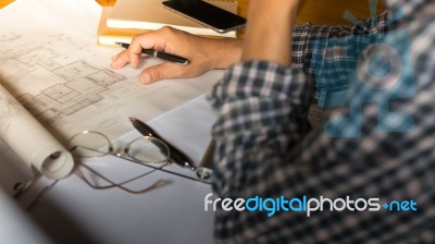 Creative Architect Projecting On The Big Drawings In The Dark Lo… Stock Photo