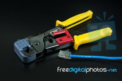 Crimping Tool For Twisted Pair On Black Background Stock Photo