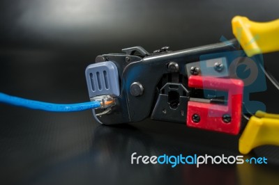 Crimping Tool For Twisted Pair On Black Background Stock Photo