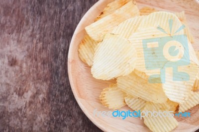 Crispy Potato Chips On Wooden Background Stock Photo