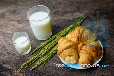 Croissant On Dish With Rice Milk And Ear Of Rice  On Old Wooden Stock Photo