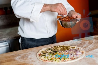 Cropped Image Of A Chef Preparing Pizza Stock Photo