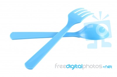Cross Blue Plastic Spoon And Fork On White Background Stock Photo