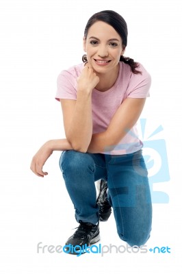 Crouched Woman Posing Casually Stock Photo