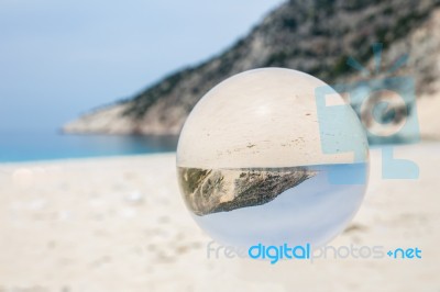 Crystal Ball On Sandy Greek Beach Stock Photo