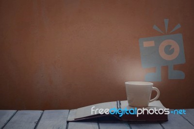 Cup And Book On Wooden Stock Photo