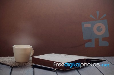 Cup And Books On A Wooden Stock Photo