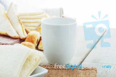 Cup And Bread On Table Stock Photo