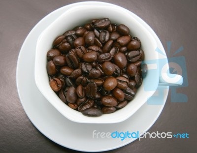 Cup Filled With Coffee Beans Stock Photo