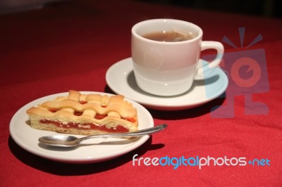 Cup Of Tea With Cake Served On The Table Stock Photo