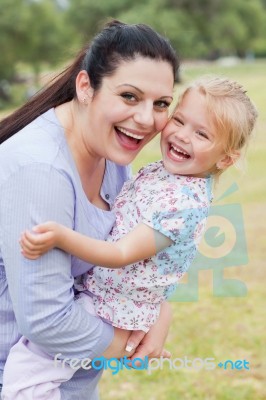 Curious Mother Carrying Her Daughter With Big Smile Stock Photo Curious Mother Carrying Her Daughter With Big Smile Stock Photo