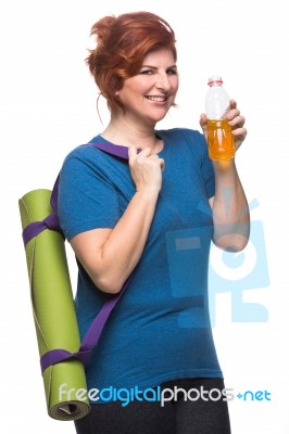 Curvy Woman Carrying Yoga Mat Stock Photo