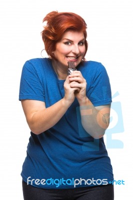 Curvy Woman Eating Chocolate Stock Photo