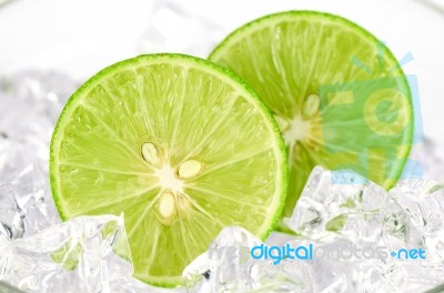 Cut Lime (citrus Aurantifolia (christm.)  Swingle) And Ice On Wh… Stock Photo