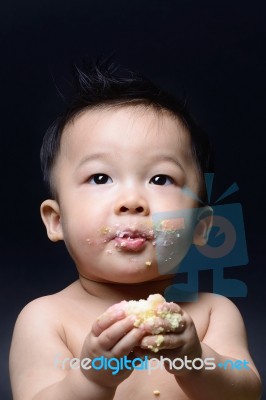 Cute Asian Baby Boy Eating Cake With His Both Hand And Messy On Stock Photo
