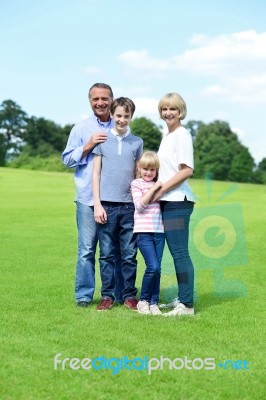 Cute Family Of Four Posing To Camera Stock Photo