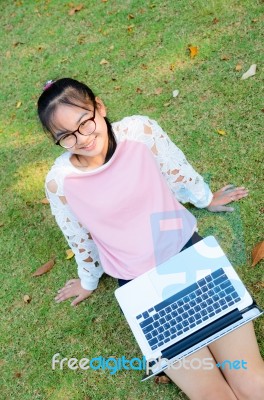 Cute Girl Is Happy With Notebook On Grass Stock Photo