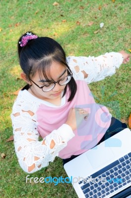 Cute Girl Is Happy With Notebook On Grass Stock Photo