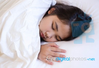 Cute Girl Sleeping On A White Bed Stock Photo