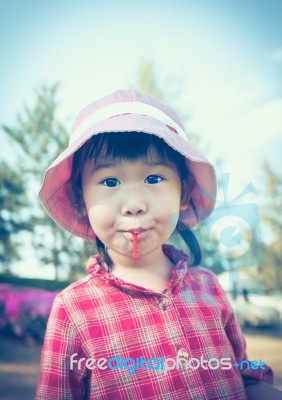 Cute Little Asian Girl Eating A Lollipop On Nature Background In… Stock Photo Cute Little Asian Girl Eating A Lollipop On Nature Background In… Stock Photo
