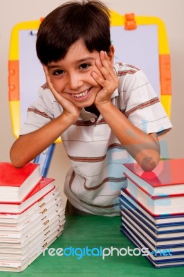 Cute Young Boy Resting On Books Stock Photo