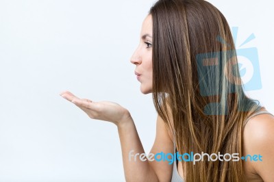 Cute Young Woman Blowing A Finger Kiss Stock Photo