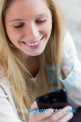 Cute Young Woman Chatting With Their Smartphone Stock Photo
