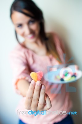 Cute Young Woman Eating Jelly Candies With A Fresh Smile Stock Photo Cute Young Woman Eating Jelly Candies With A Fresh Smile Stock Photo